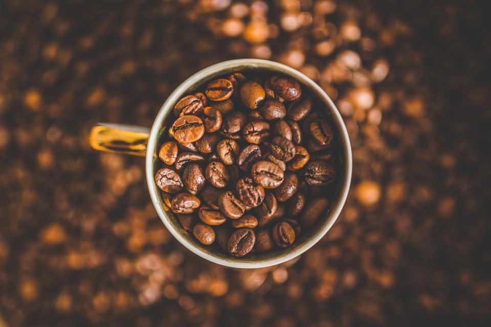 A cupping glass filled with roasted Ethiopia Guji beans, shot from above